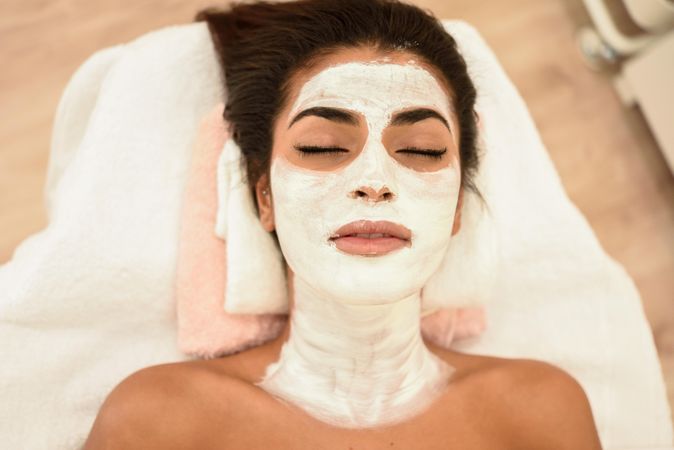 Woman lying back with facemask