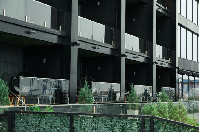 Dark hotel room balconies and outdoor bushes