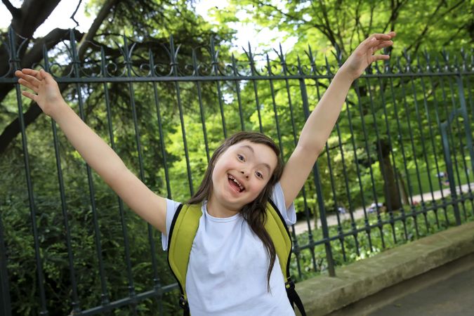 Female child throwing her arms up in excitement