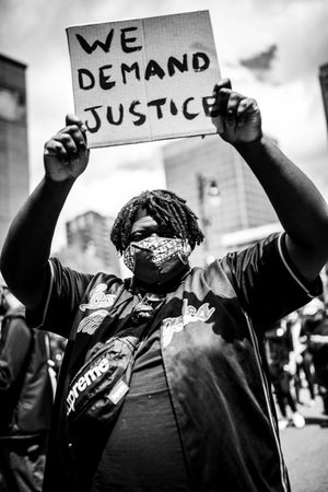 MONTREAL, QUEBEC, CANADA – June 7 2020- protester holding a sign during a Black Lives Matter protest