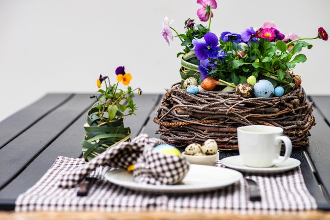 Easter table setting with checkered brown napkin and nest center piece