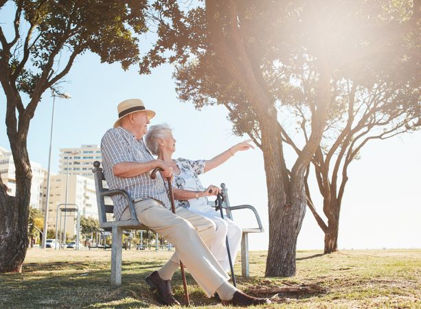 Mature couple taking a break and relaxing on a bench