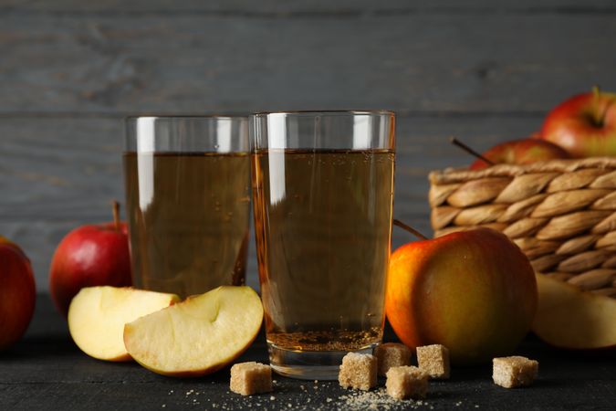 Composition with cider, sugar and apples on wooden background