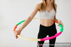 Cropped image of woman holding a colorful hoop bEXKl4