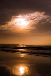 Beautiful evening sky over waving sea and shore