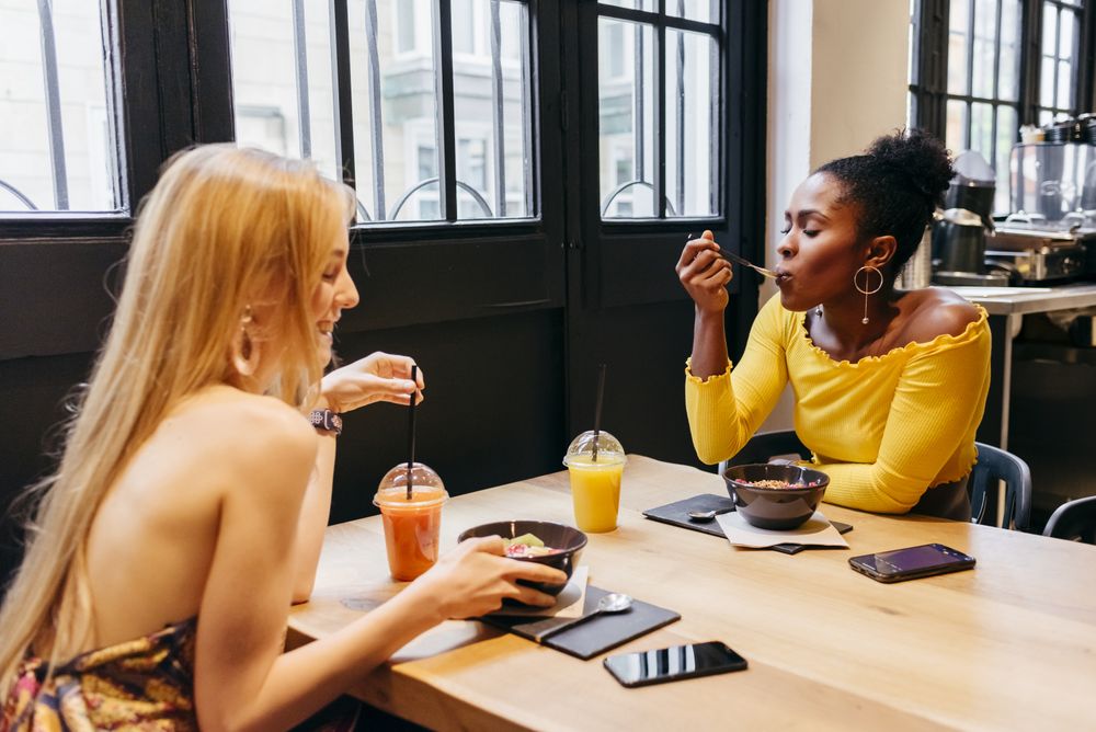Two friends having lunch at cafe