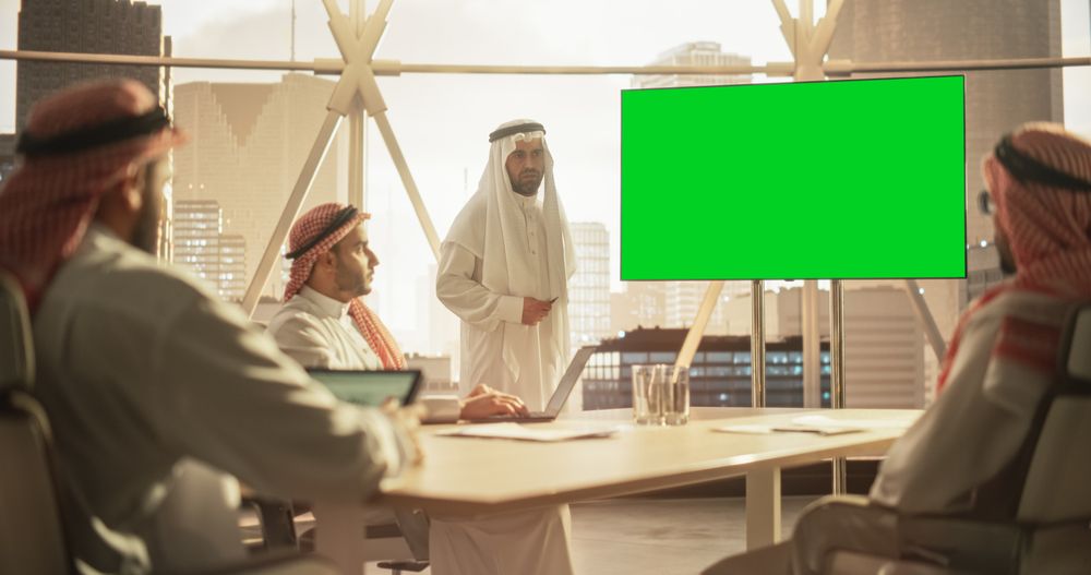 Arab Businessman Shows Data to a Group of Saudi Investors.