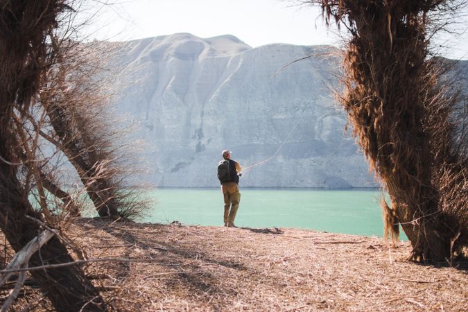 Man fishing near lake