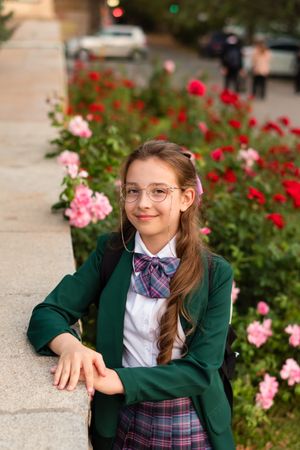 Girl in school uniform smiling gently