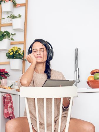 Content woman listening to music in headphones