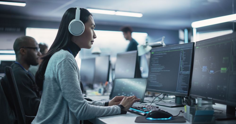 Portrait of a Thoughtful Young Engineer Working on Computer in a Technological Office Environment.