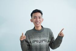 Asian young man pointing