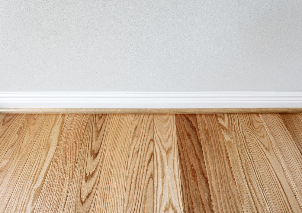 New red oak floor with trim against wall