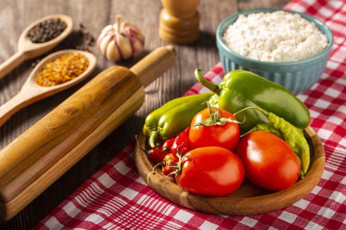 Wooden table with ingredients for pizza.
