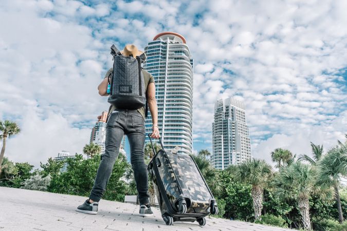 Back view of hipster man watching the skyscraper background,