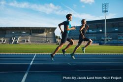 Two young men running on race track - Free Photo (412Apb) - Noun