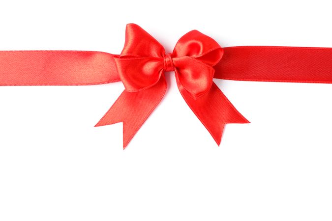 Red ribbon with bow isolated on blank background. Gift concept