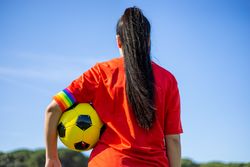 Female soccer player with rainbow armband