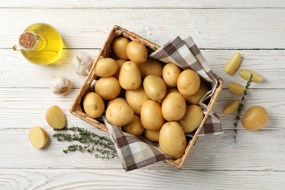 Looking down at box of potatoes on rustic background