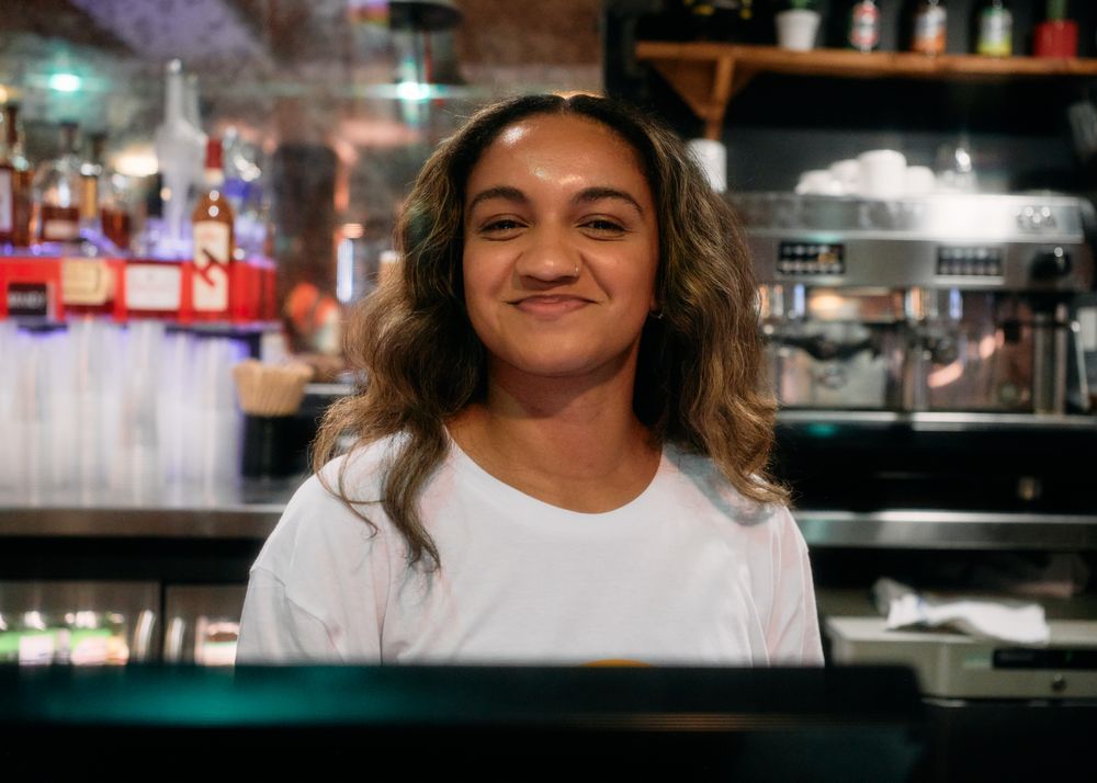 London, England, United Kingdom - August 28, 2022: Female behind bar
