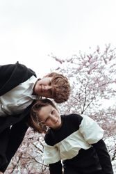 Smiling siblings standing in park