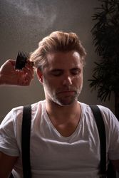 Portrait of man getting haircut