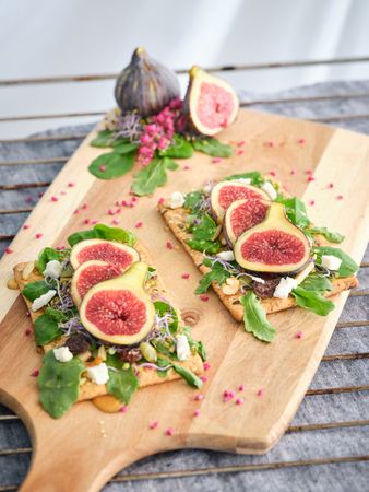 Toasts with figs on cutting board
