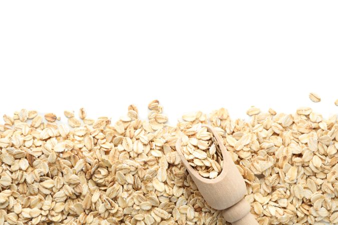 Scoop and oatmeal flakes frame isolated on plain background