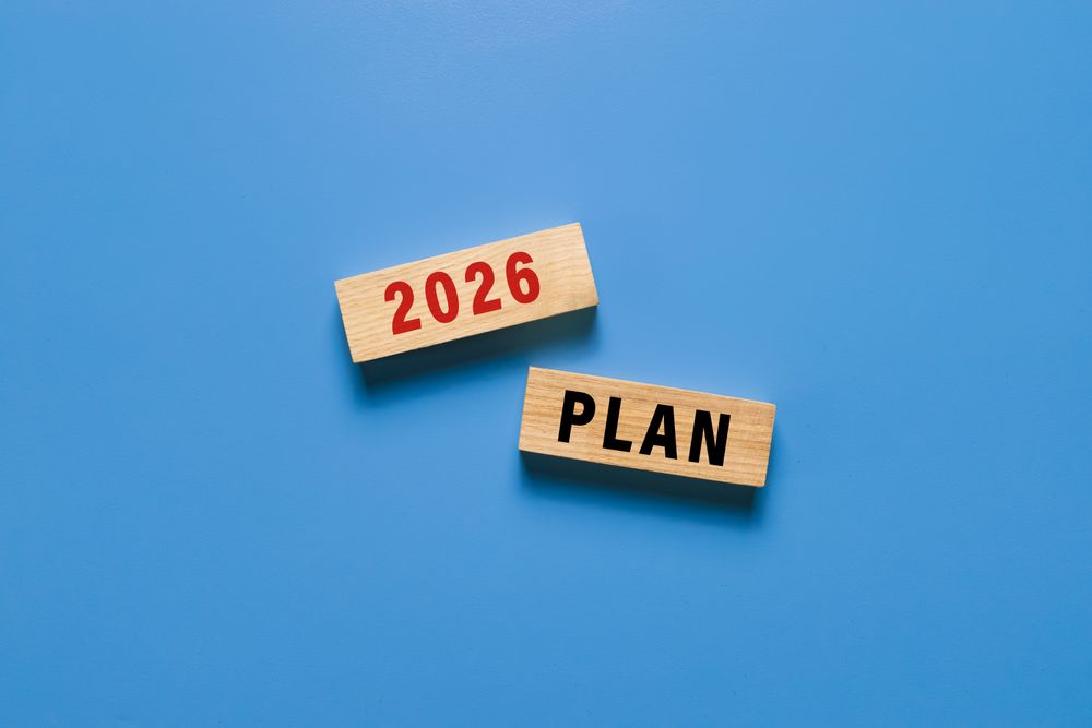 2026 plan text symbol on wooden blocks isolated on blue background