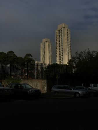 Cars parked near high rise building in Redfern, New South Wales, Australia during evening