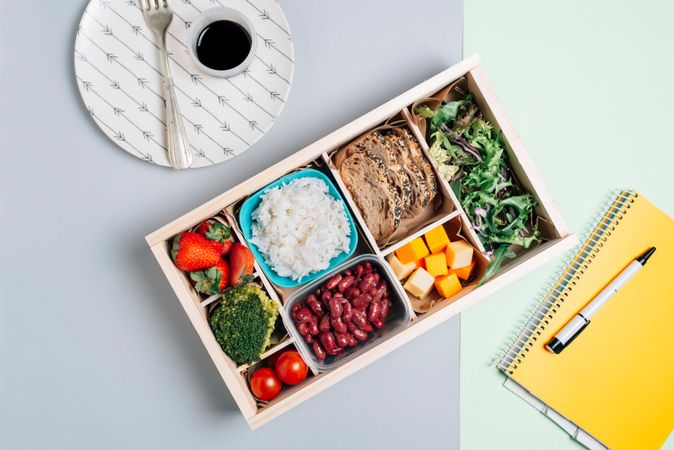 Food box with diet ingredients by copybook and plate