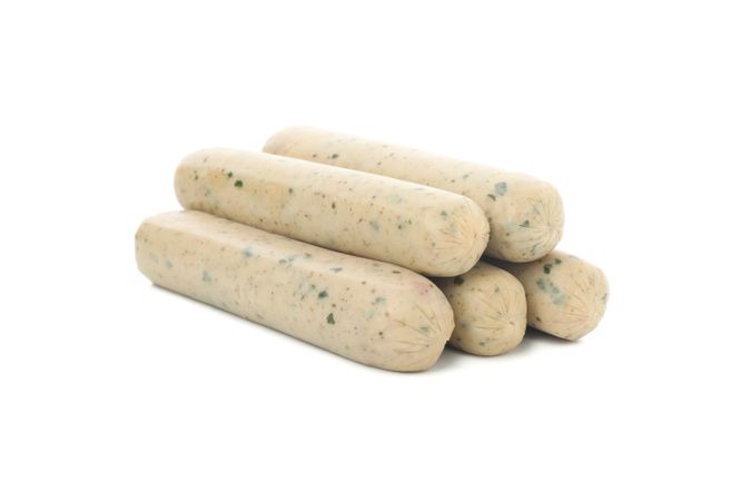 Light colored sausages piled on blank background