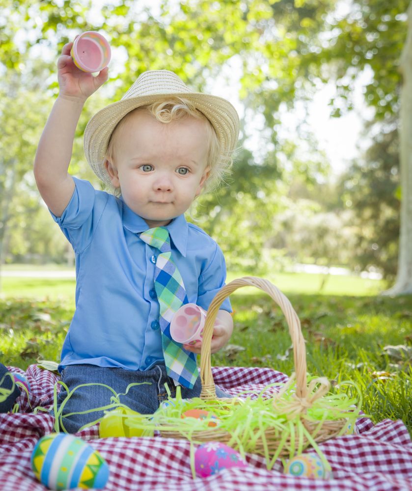 Cute Little Boy Enjoying His Easter Eggs Outside in Park