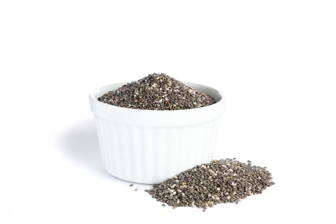 Chia seeds and sauce boat isolated on blank background