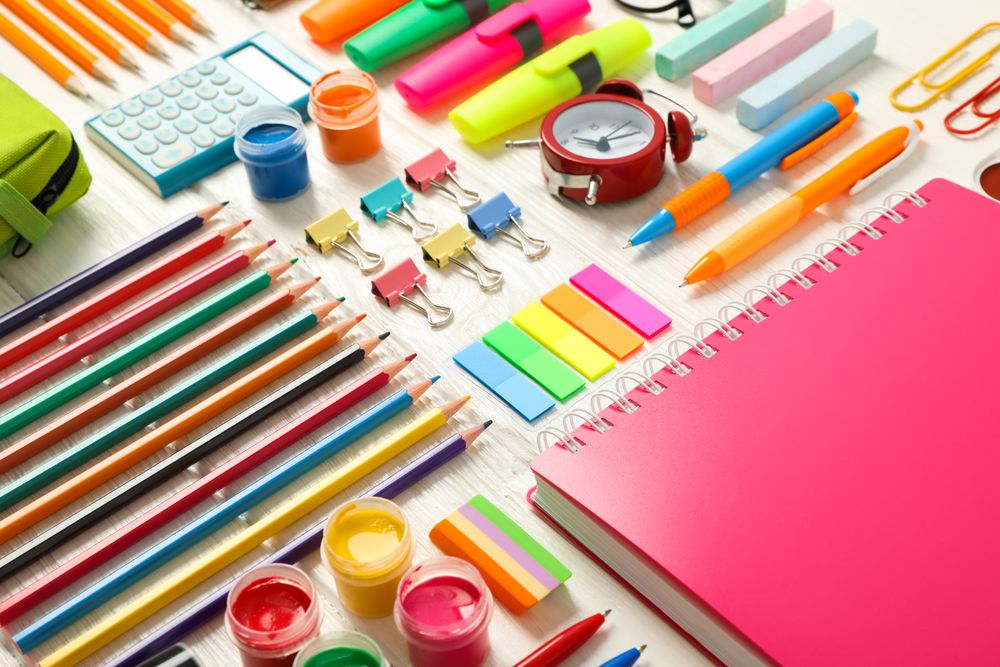 Flat lay composition with school supplies on wooden background