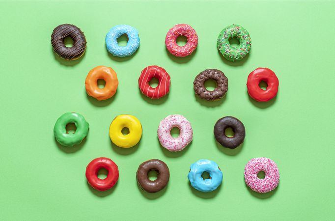 Donuts variety top view on a green background
