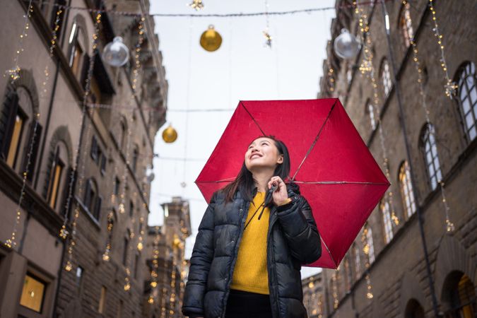 Cheerful Asian traveler exploring old street