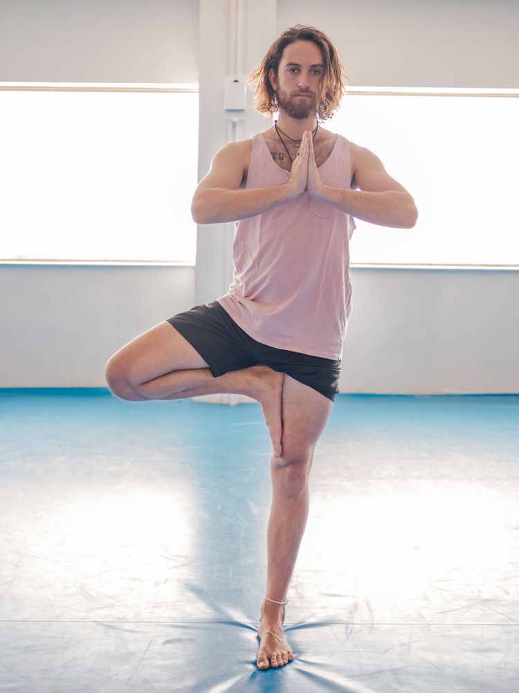 Male doing yoga in spacious room
