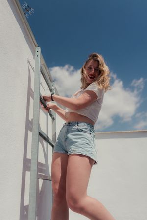 Female hipster in stylish casual clothing on stairs at roof