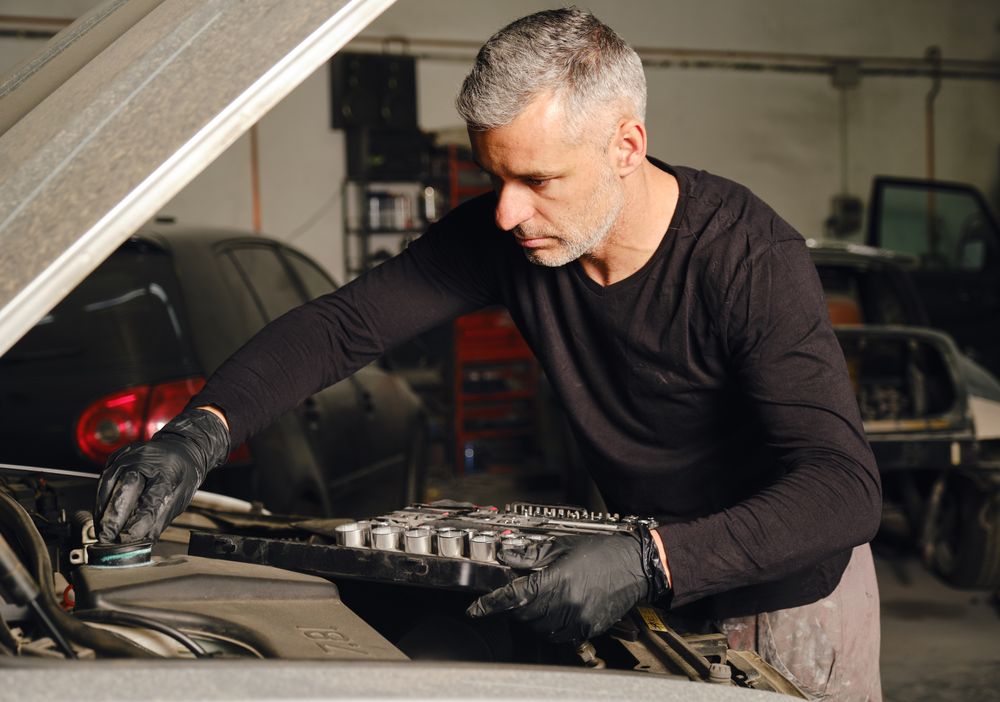 Adult man repairing car