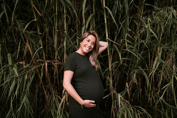 Pregnant woman standing in garden