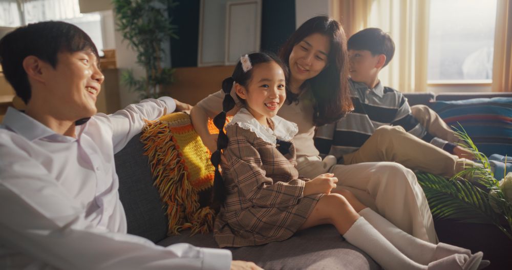 Beautiful Family Happily Embracing, Discussing and Imagining How to Decorate Their New Home