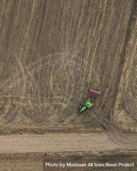 Aerial view of tractor working on farmland 0JQVwb