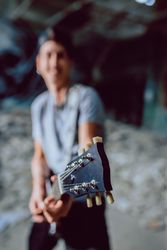 Musician playing electric guitar in abandoned place
