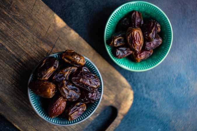 Top view of two bowls of organic dates on table