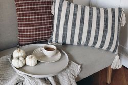 Still life decorative details at home with cup of coffee, round serving tray, little pumpkins
