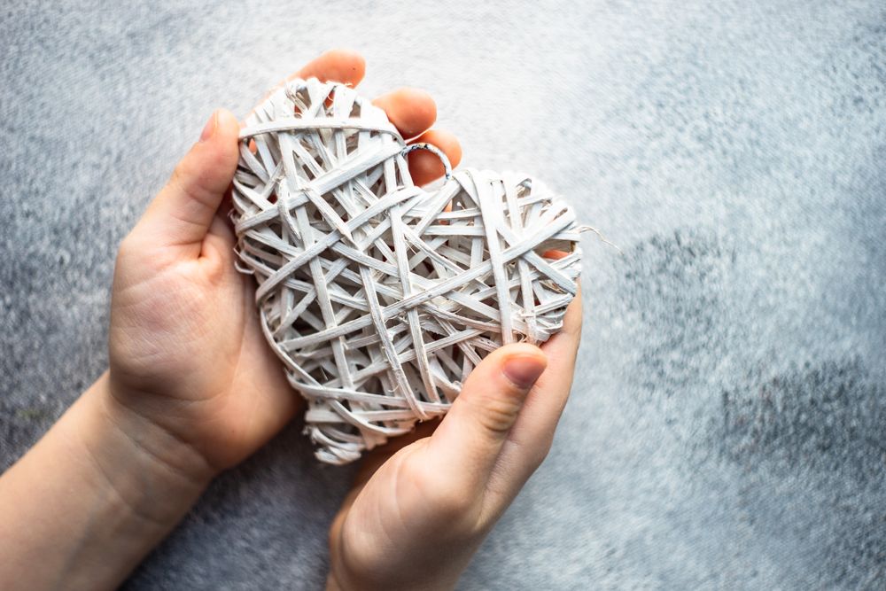 Thatched heart decoration held in two hands