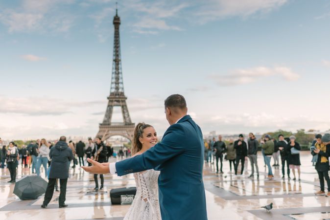 Happy newlyweds in wedding clothing dancing together