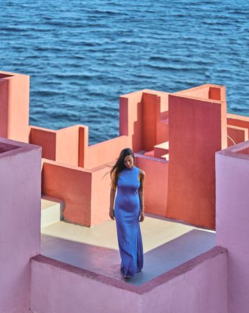 Woman in blue fur dress on the roof of a building