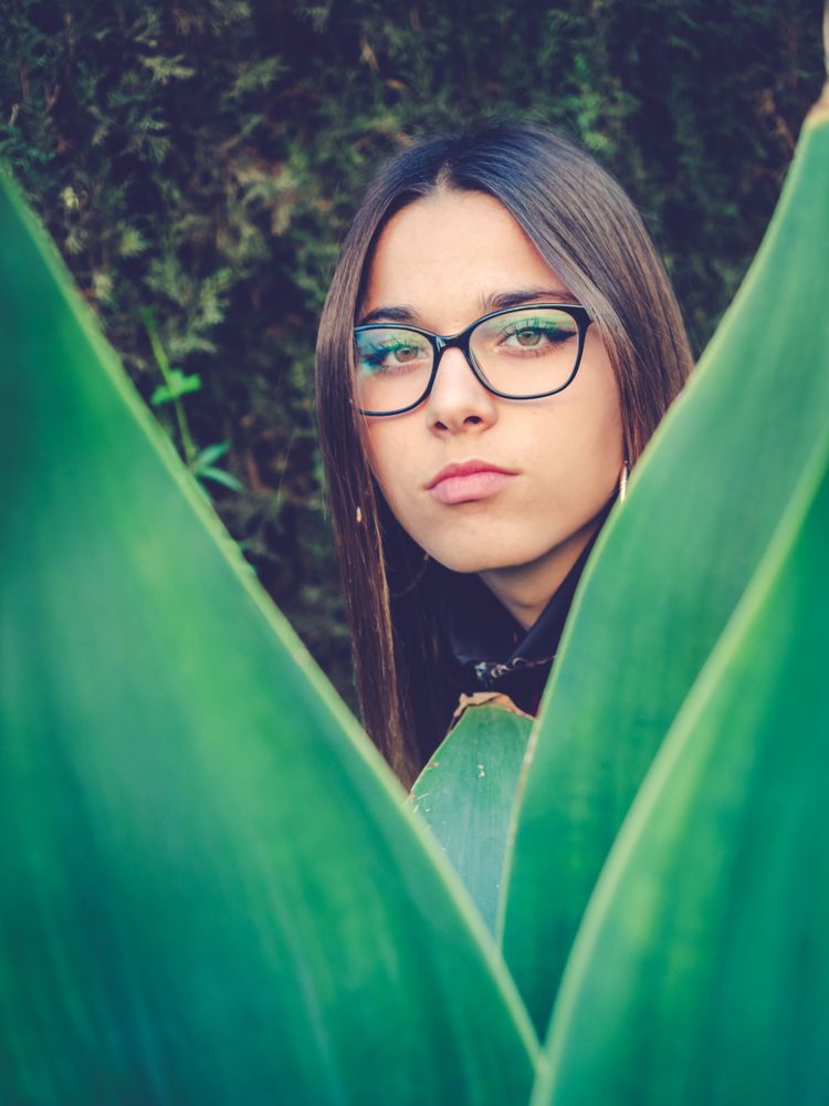 Woman between green leaves